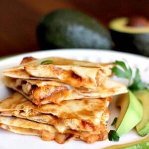 Chicken enchilada quesadillas stacked on a plate