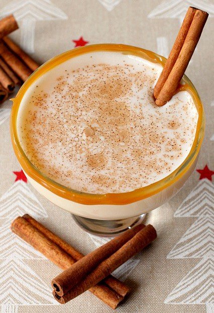 An Eggnog Cocktail is made with eggnog, amaretto and vodka, then rimmed with caramel and garnished with cinnamon.