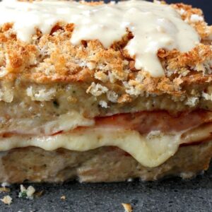 A chicken meatloaf with layers of ham and cheese and a dijon cream sauce