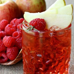 raspberry whiskey drink with apple slices
