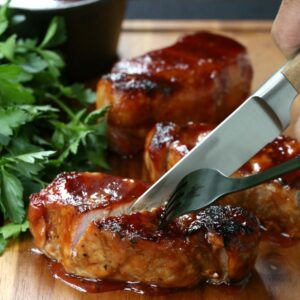 bbq pork chops being cut with a knife