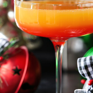 mimosa recipe with grenadine and Christmas decorations in the background
