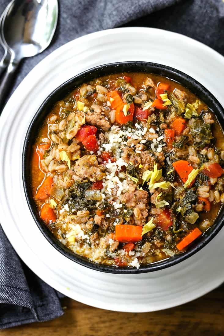 bowl of sausage soup with spinach and farro