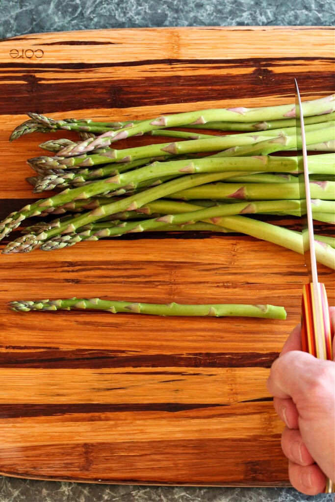 cutting asparagus on board