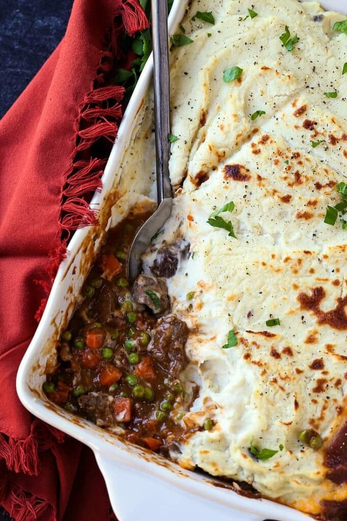 Guinness Beef Shepherd's Pie with a spoon in the casserole dish