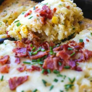 Spoon bread with bacon and cheese on a serving spoon