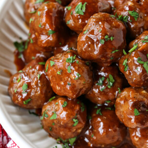 meatballs in a white bowl with bbq sauce