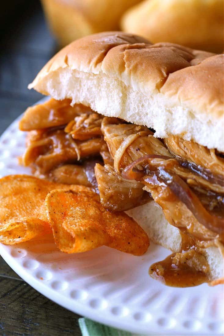 sweet pulled chicken on a roll with chips on the side