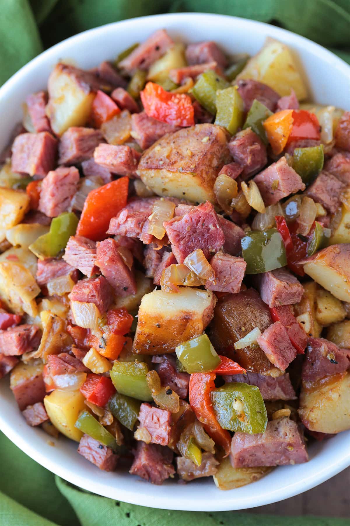 bowl of corned beef hash with green napkin