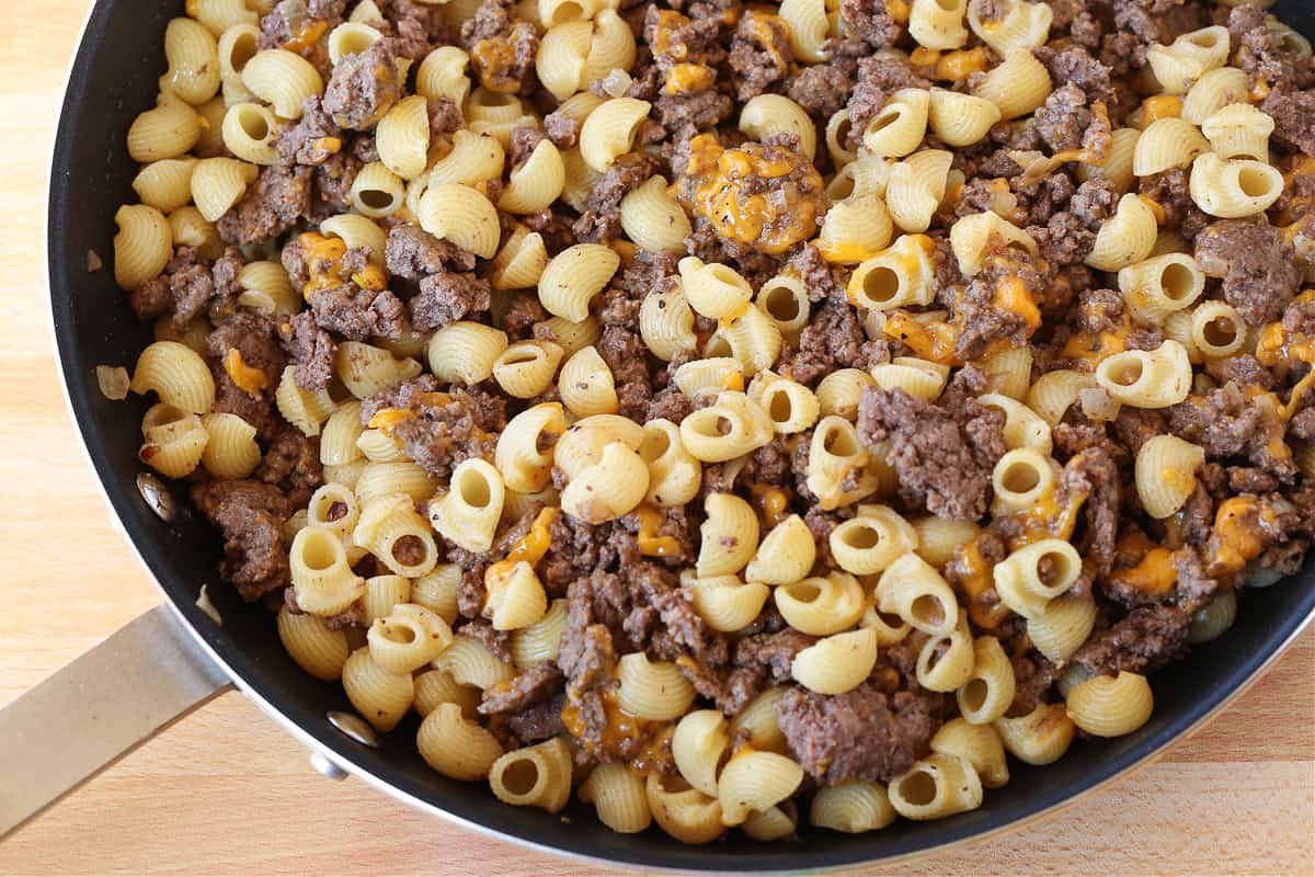 pasta, ground beef and cheese mixed in a skillet