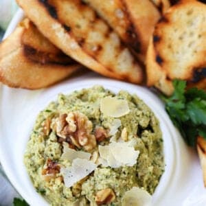 Walnut pesto with artichokes and parmesan cheese in a serving dish