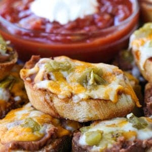 Cheese crostini appetizer on a platter with salsa