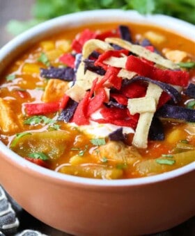 Chicken Fajita Soup in a bowl with napkin and spoons