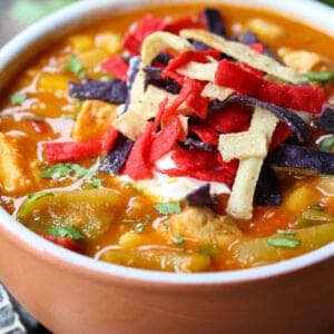 Chicken Fajita Soup in a bowl with napkin and spoons