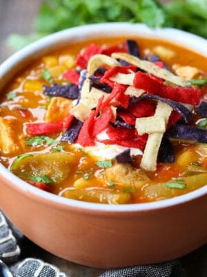 Chicken Fajita Soup in a bowl with napkin and spoons