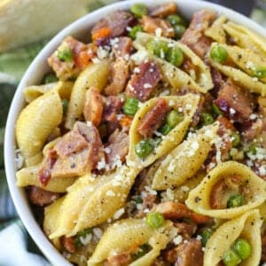 Pasta with Ham and Peas recipe in a bowl with green napkin