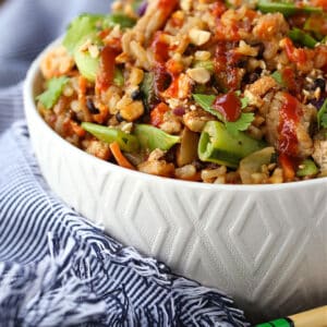 Fried Rice recipe with ground chicken and peanut sauce in a white bowl with chopsticks