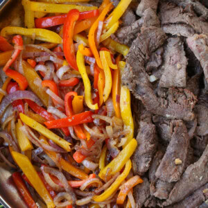 peppers, onions and steak in skillet for making fajitas