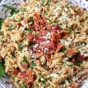 orzo recipe with bacon and parmesan cheese in grey bowl