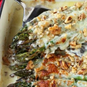 Asparagus in a baknig dish with cheese and walnuts