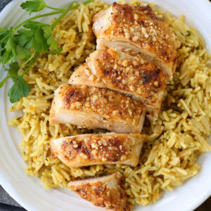sliced chicken breast on bed of rice pilaf