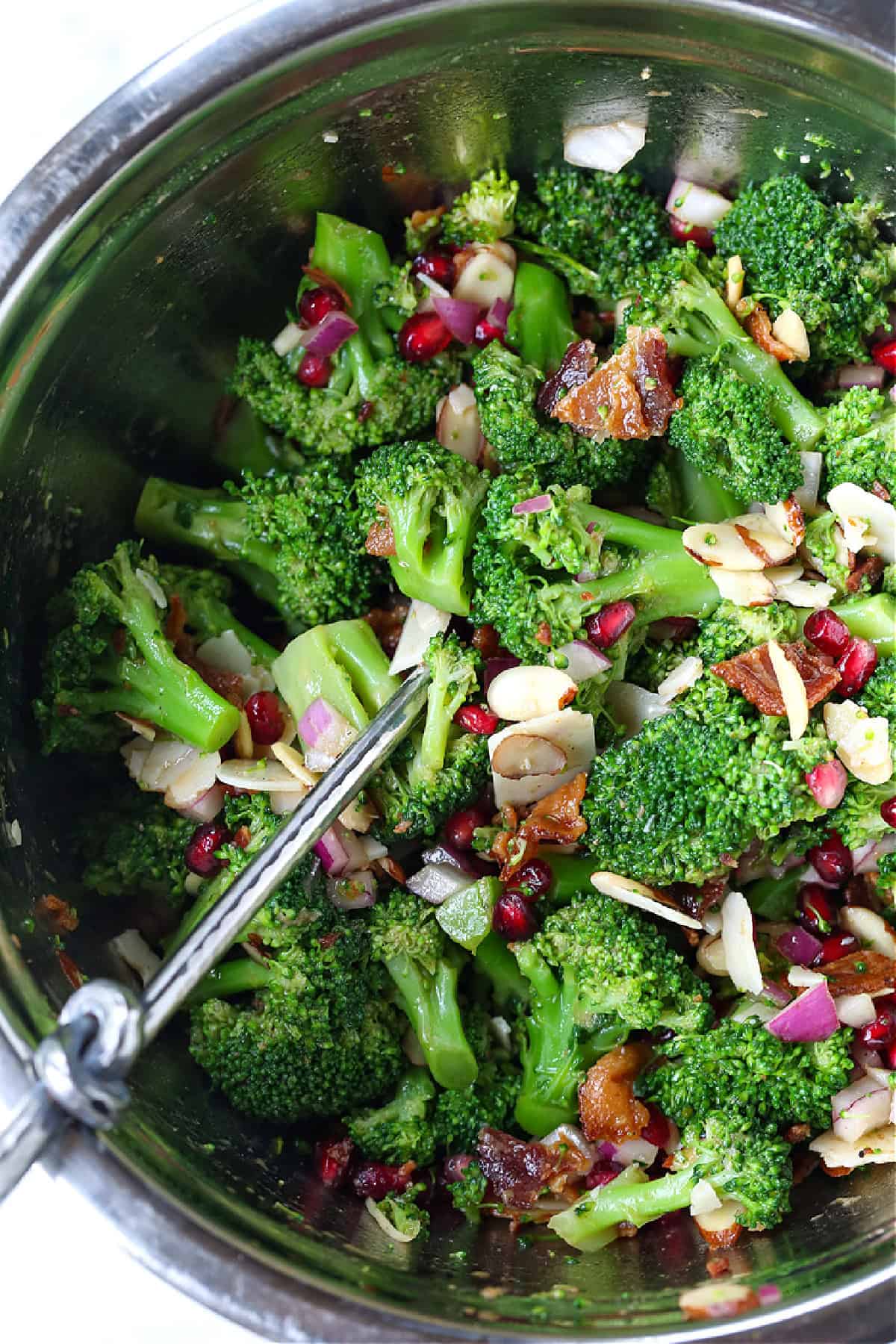 broccoli salad in metal bowl with spoon