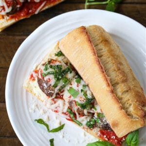 meatball sub on a plate with subs in the background