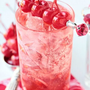 pink vodka cocktail with cherries for garnish