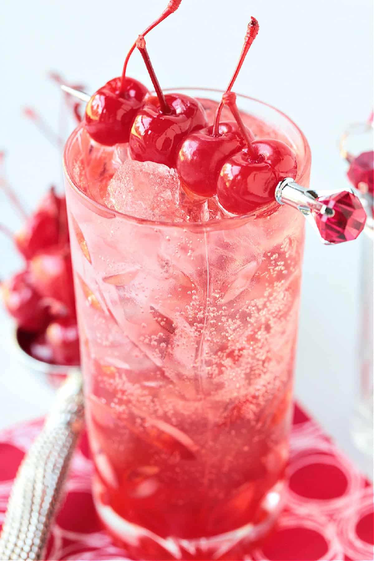 pink vodka cocktail with cherries for garnish