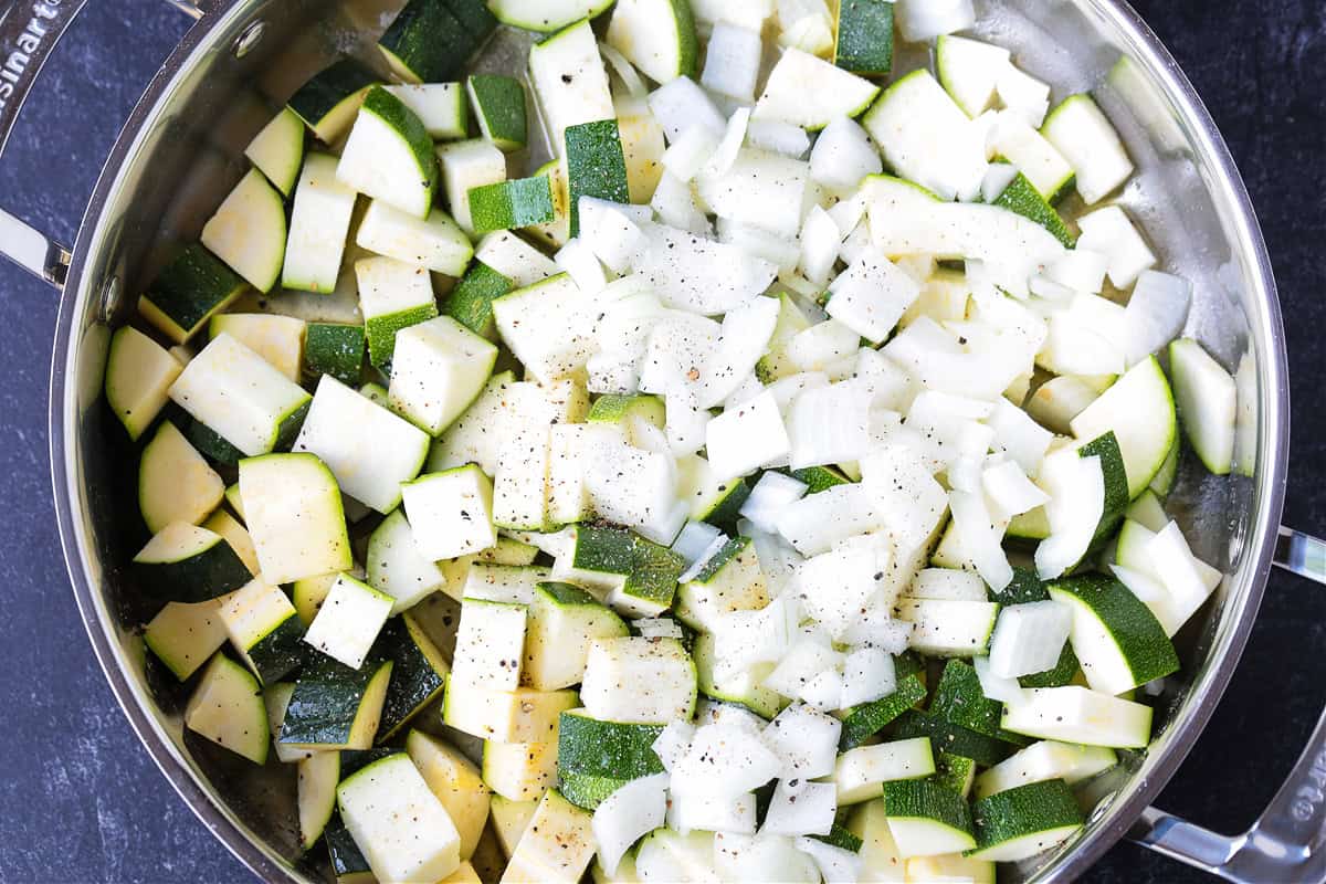 diced zucchini and onions in a skillet