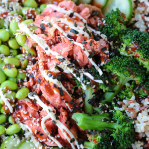 salmon and vegetables in a bowl with sriracha mayonnaise