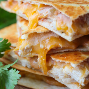 chicken quesadillas stacked on a board