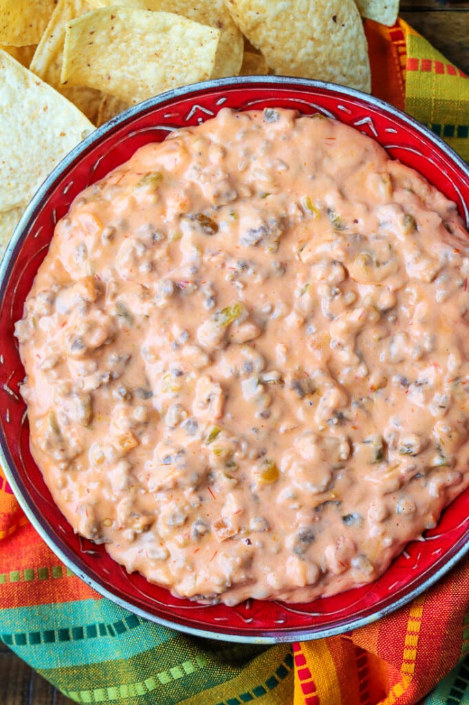 sausage cheese dip in bowl with chips on the side