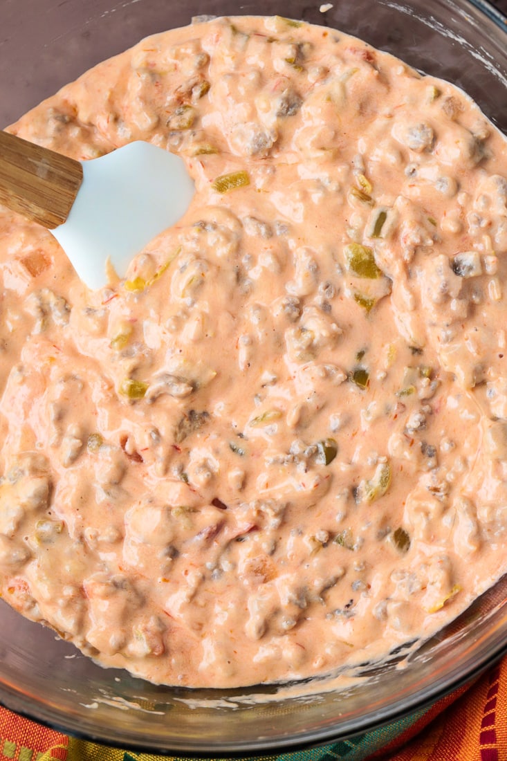 bowl of sausage and cheese dip with spatula