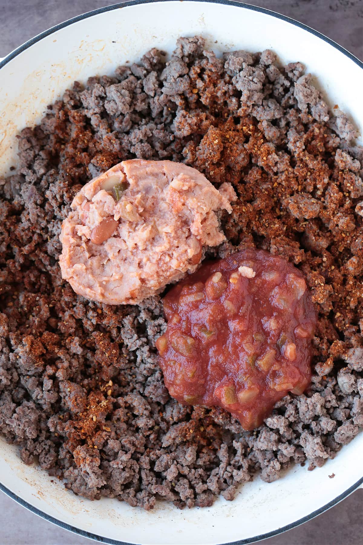 ground beef, refried beans and salsa for making taco recipe
