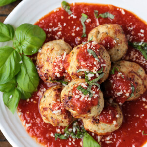 turkey meatballs stacked on plate with sauce