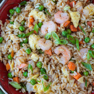 shrimp fried rice in a red bowl from the top
