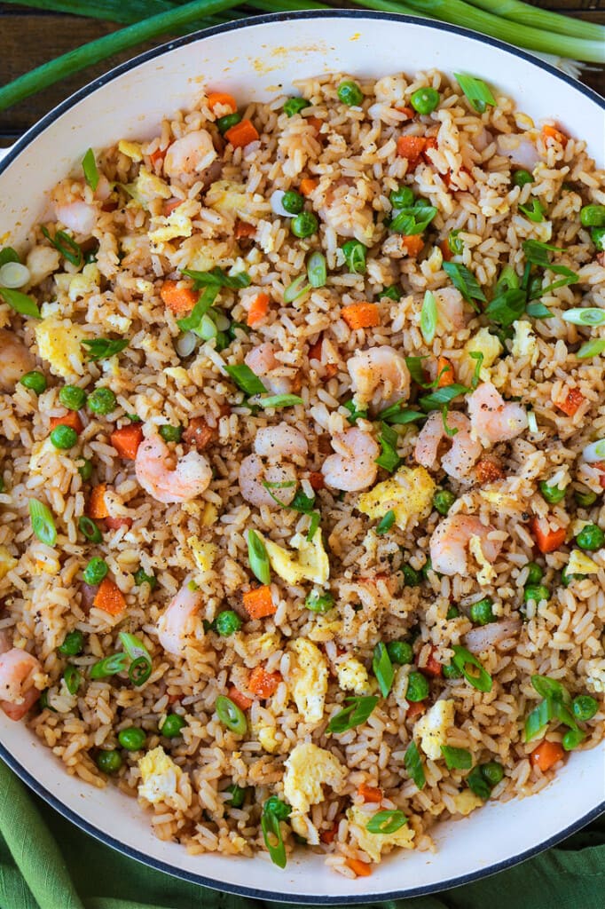 shrimp fried rice in skillet with scallions