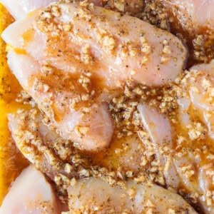 chicken breasts marinating in greek marinade