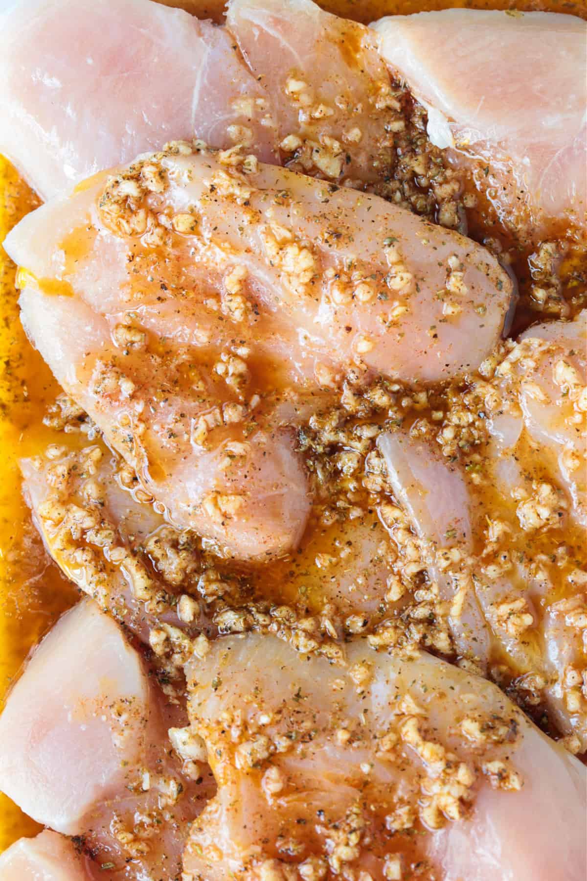 chicken breasts marinating in greek marinade
