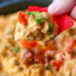 sausage queso on a red tortilla chip