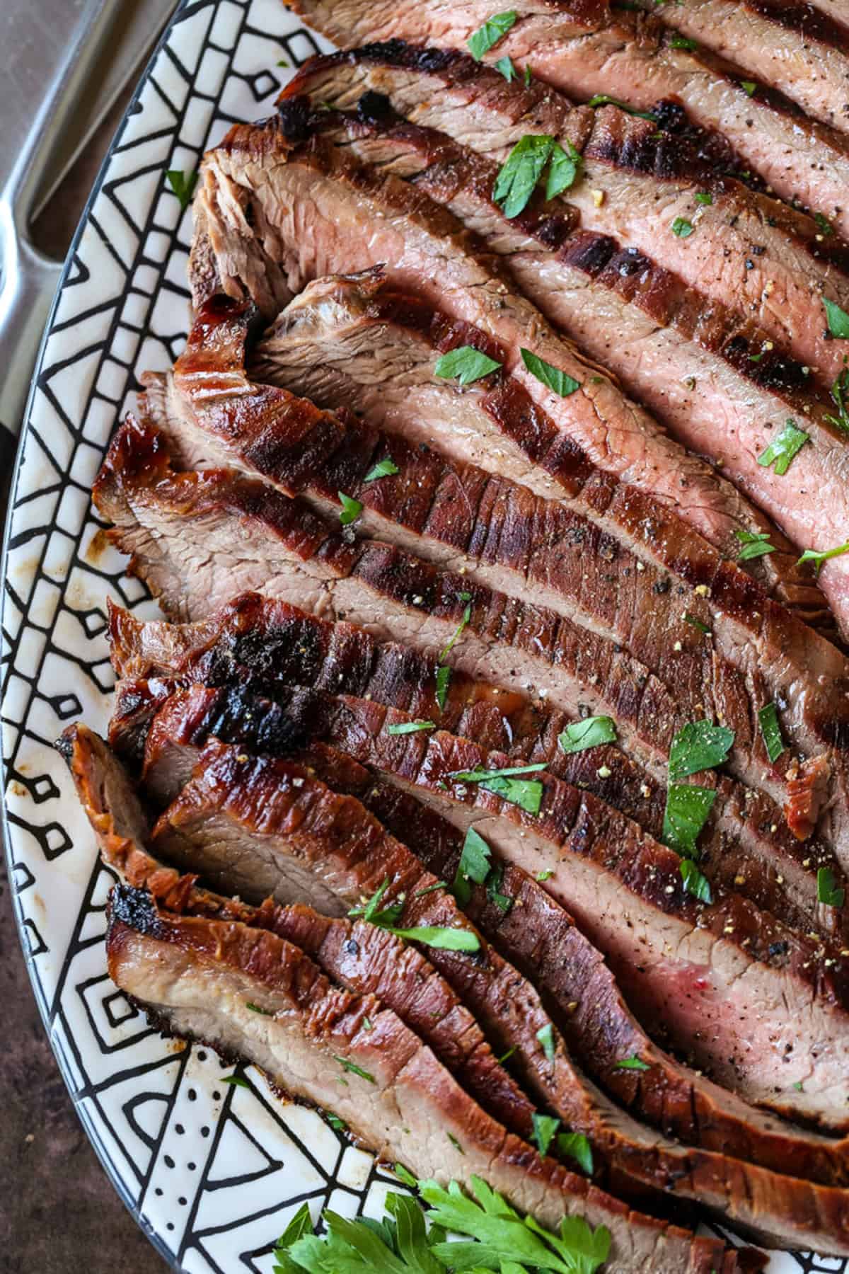 sliced flank steak on platter