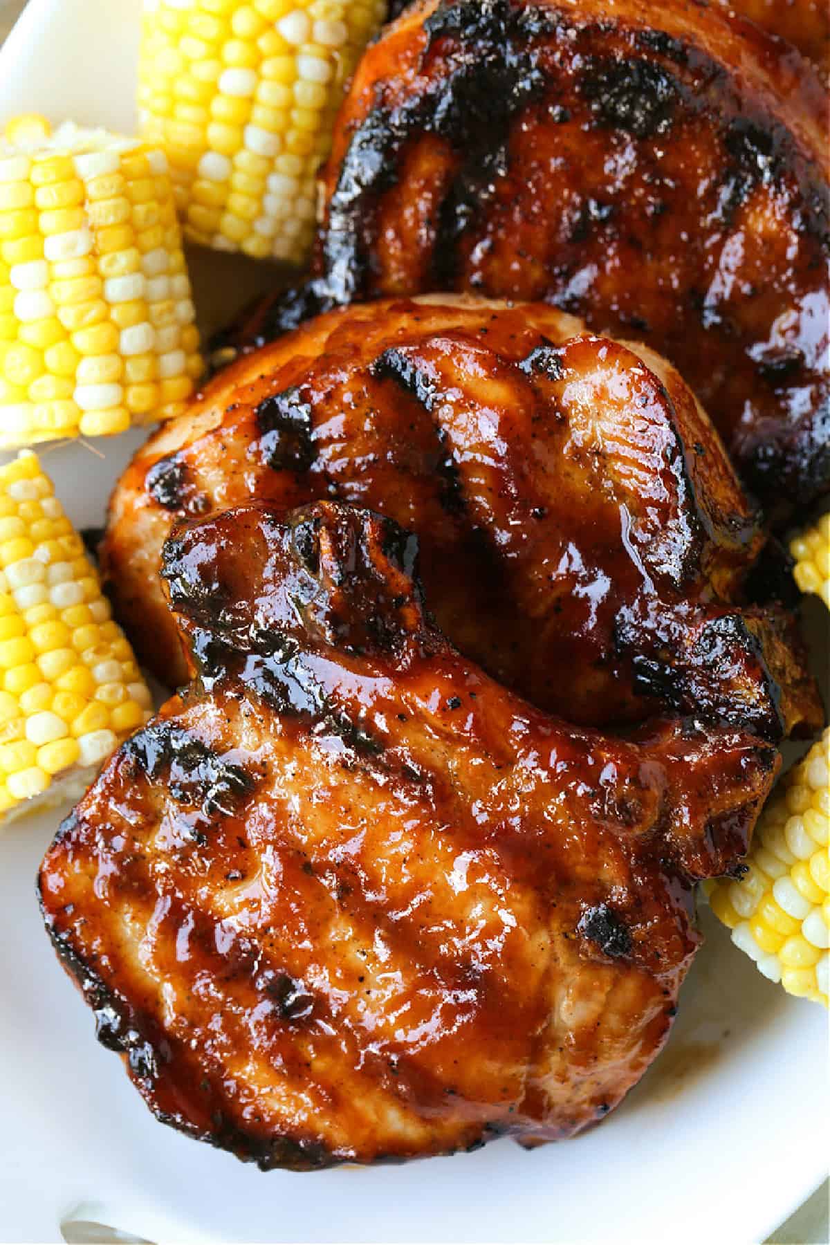 barbecue pork chops stack on a platter with corn