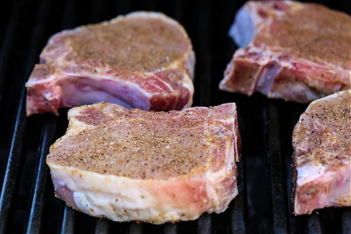 raw pork chops on the grill