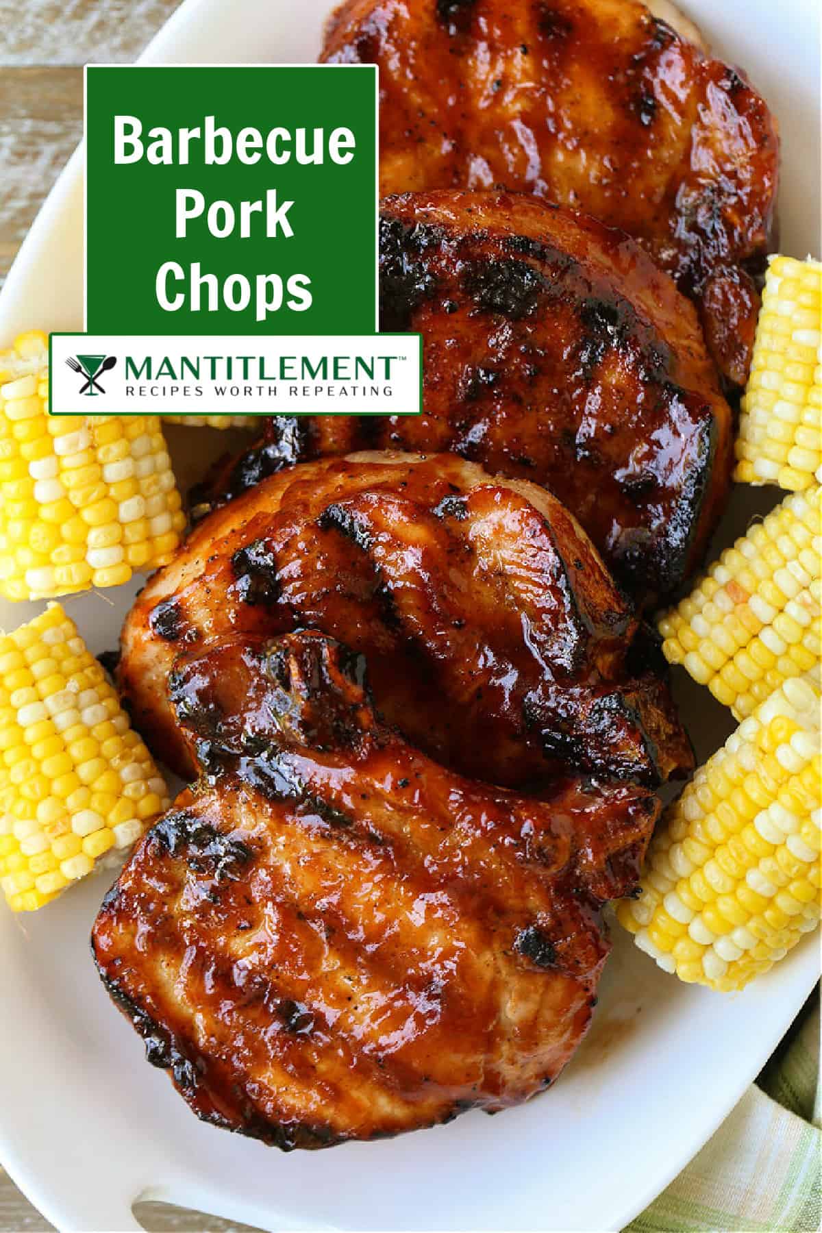 Pork chops with barbecue sauce stacked on serving platter with corn