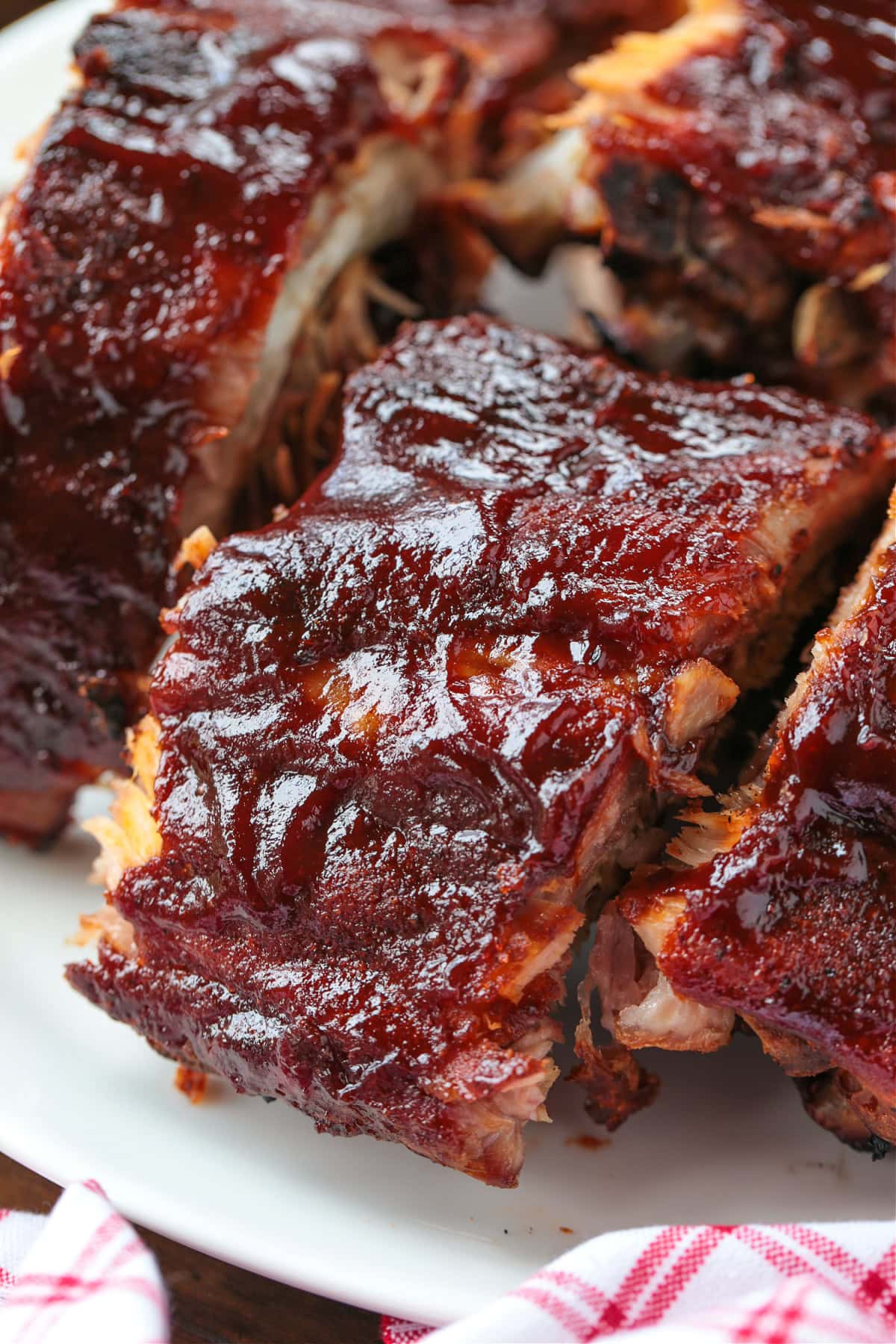 sections of barbecue ribs stacked on a plate