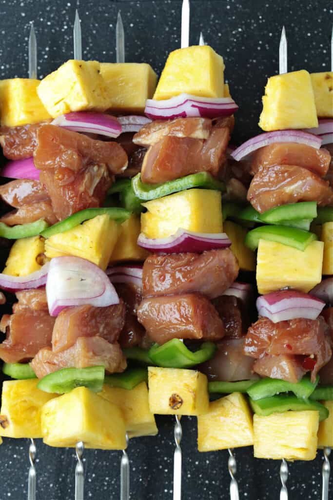 chicken, vegetables and pineapple on skewers