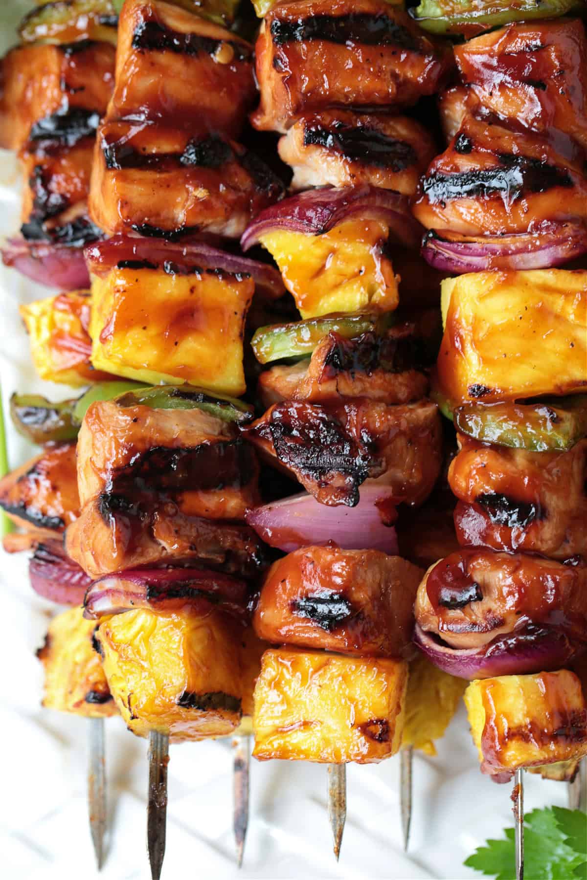 close up of chicken and pineapple kabobs on skewers