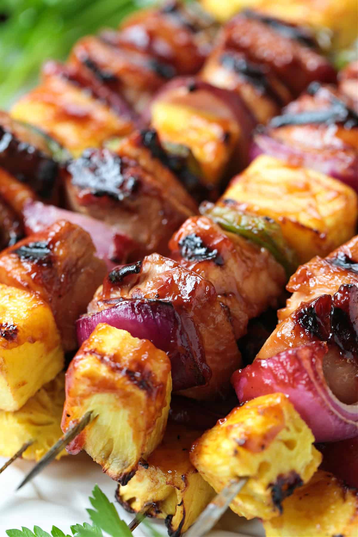 grilled chicken kabobs stacked on platter