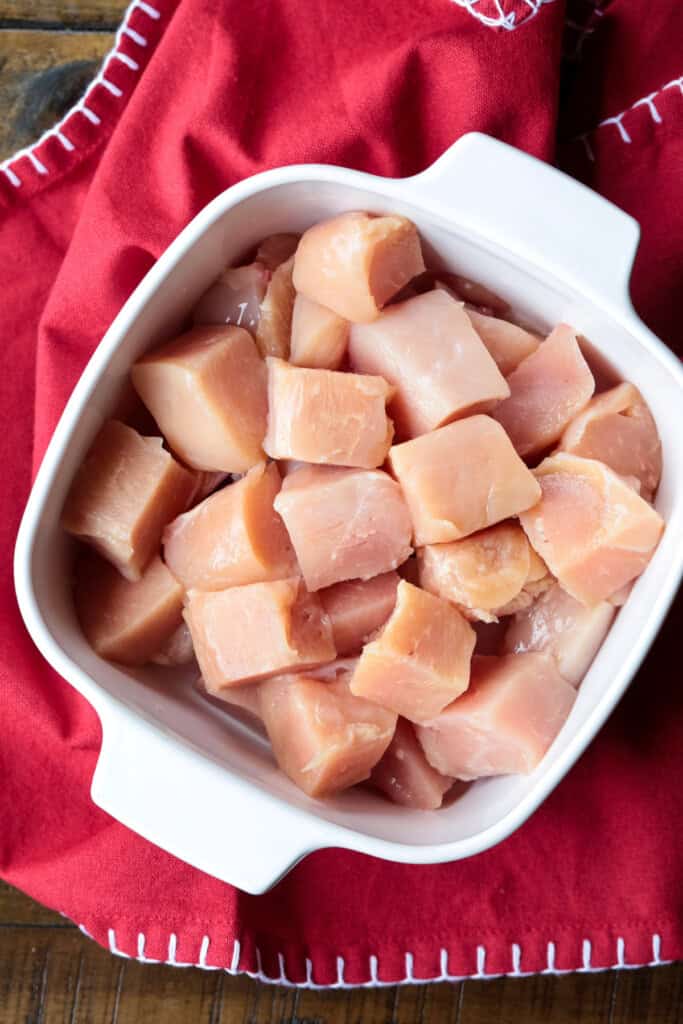 cubed chicken in dish for marinating